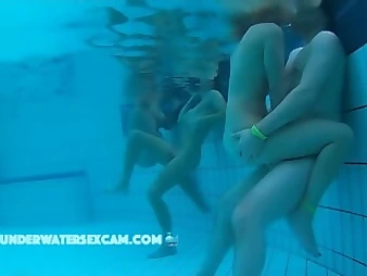 Witness these insatiable nubile honeys enjoyment each other in a public pool, no shame!
